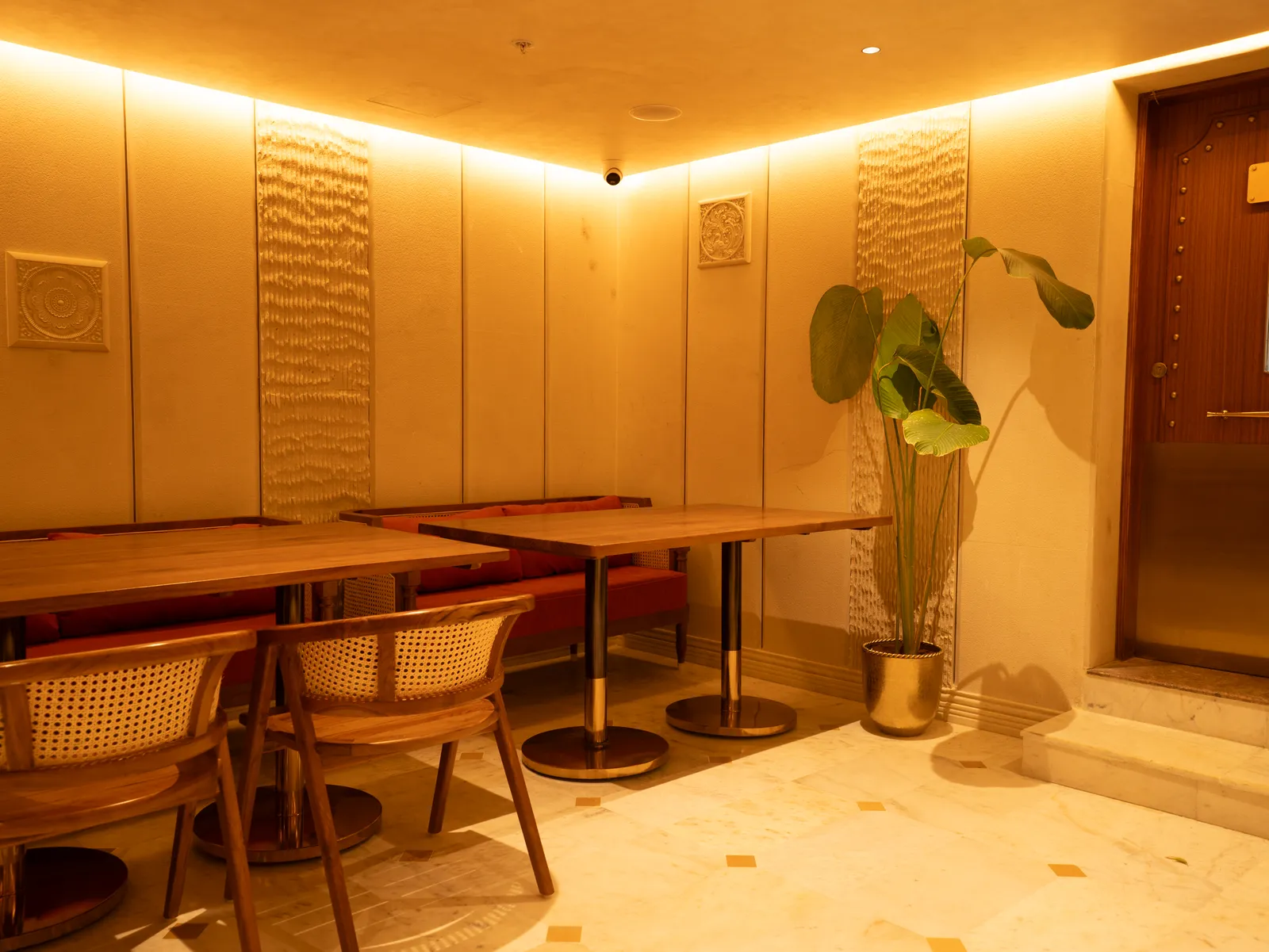 Dining area with cane chairs and wooden tables — Chalukya Samrat